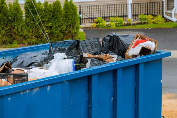 Construction trash dumpsters on metal container, house renovation.